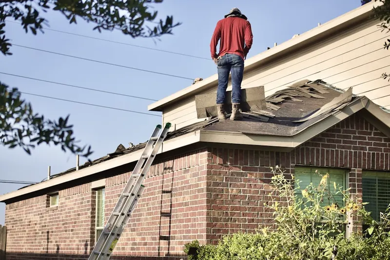 Professional roofer working on a residential roof in Colonial Wood
